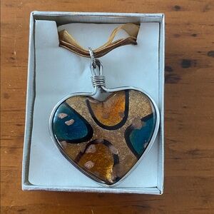 Heart shaped pendant and necklace with ribbon and cord detail silver tone clasp